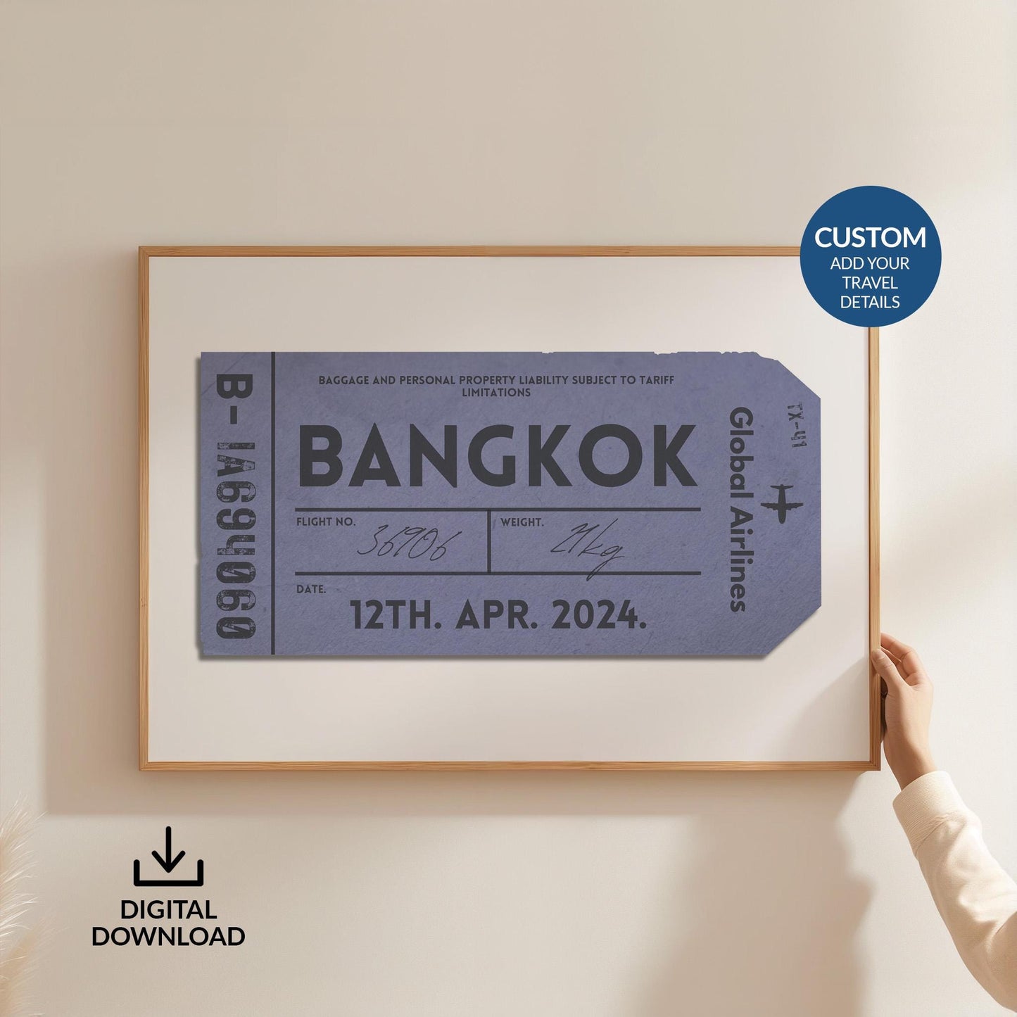 Someone in a white shirt holding up a poster is in a wood frame showing an old luggage tag design in blue which has been made bespoke with personalised text.