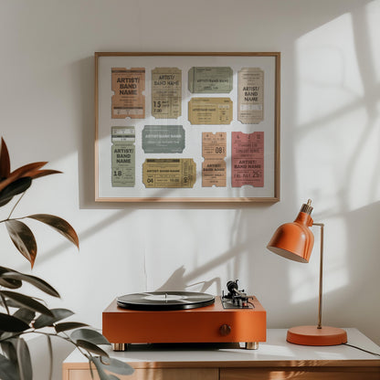 A record player and retro orange lamp are on a ounter with a landscape wall decor in an oak frame hung above. The bespoke poster shows various shaped ticket stubs for live music events. Each has a title, date venue, city and seat numbers.