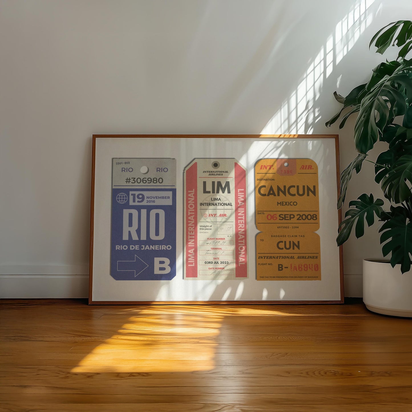 A minimalist home with a large landscape gallery wall piece on the floor. The art has vintage details inspired by a retro luggage tags