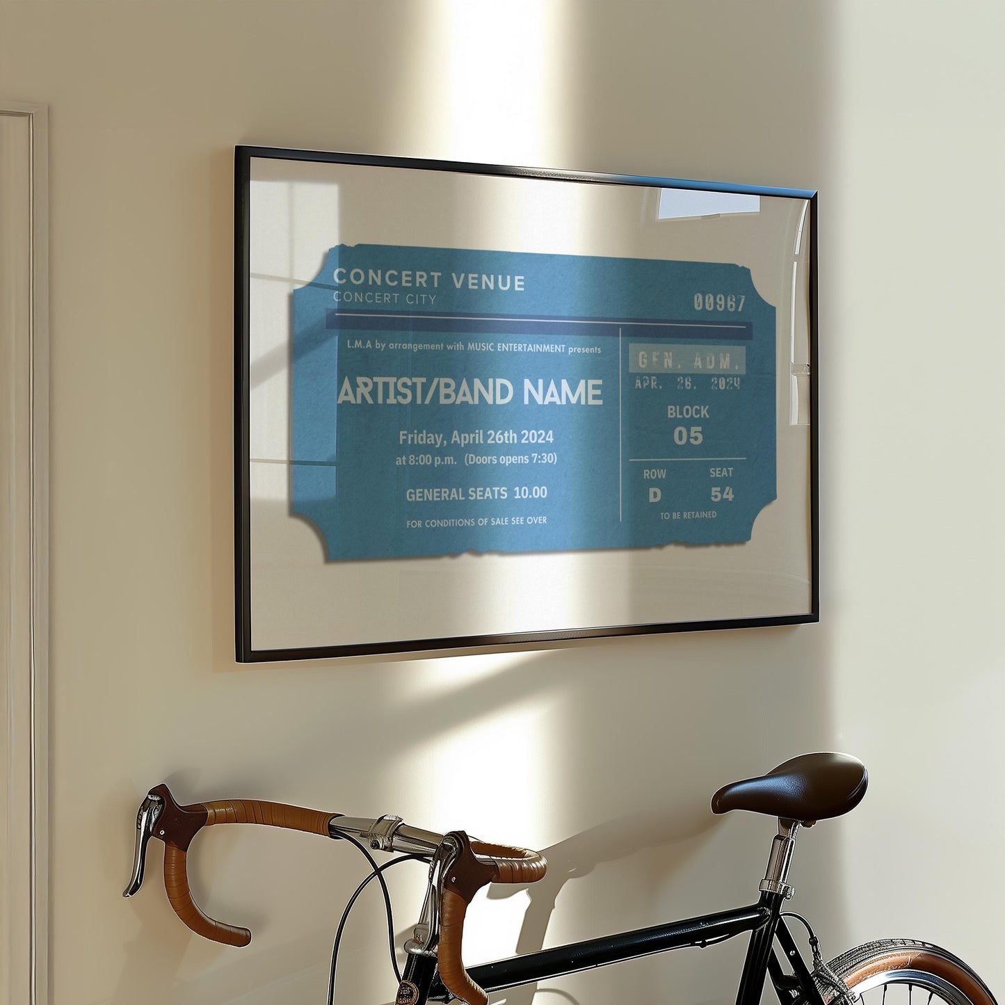 A European style apartment hallway with a bike leaning on the wall. Above is a statement art piece inspired by old concert tickets. The art shows a ticket with personalised live music event details on it.