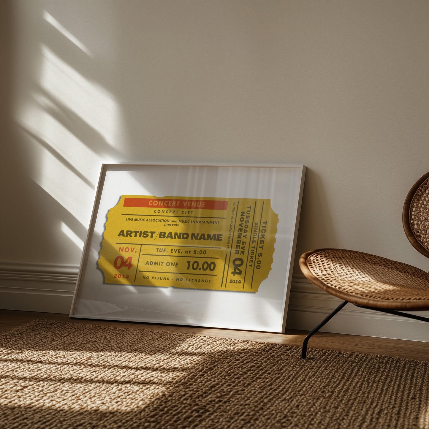 A living room with a rattan rug and chair. On the floor is a retro mustard colour poster featuring a ticket stub inspired by old concert event passes.