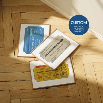 A arm herringbone parquet floor with three colourful prints laid out. The posters are designed to look like live music event passes with personalised details on them to make a music memory art piece.