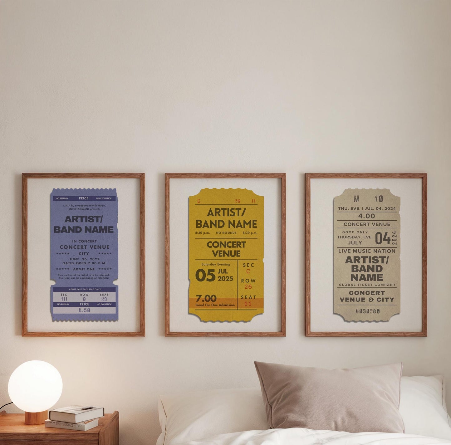 Three colourful vintage style live music prints hung over a cosy bed with a warm round lamp on a sideboard. The art is custom made for your favourite concerts and events.