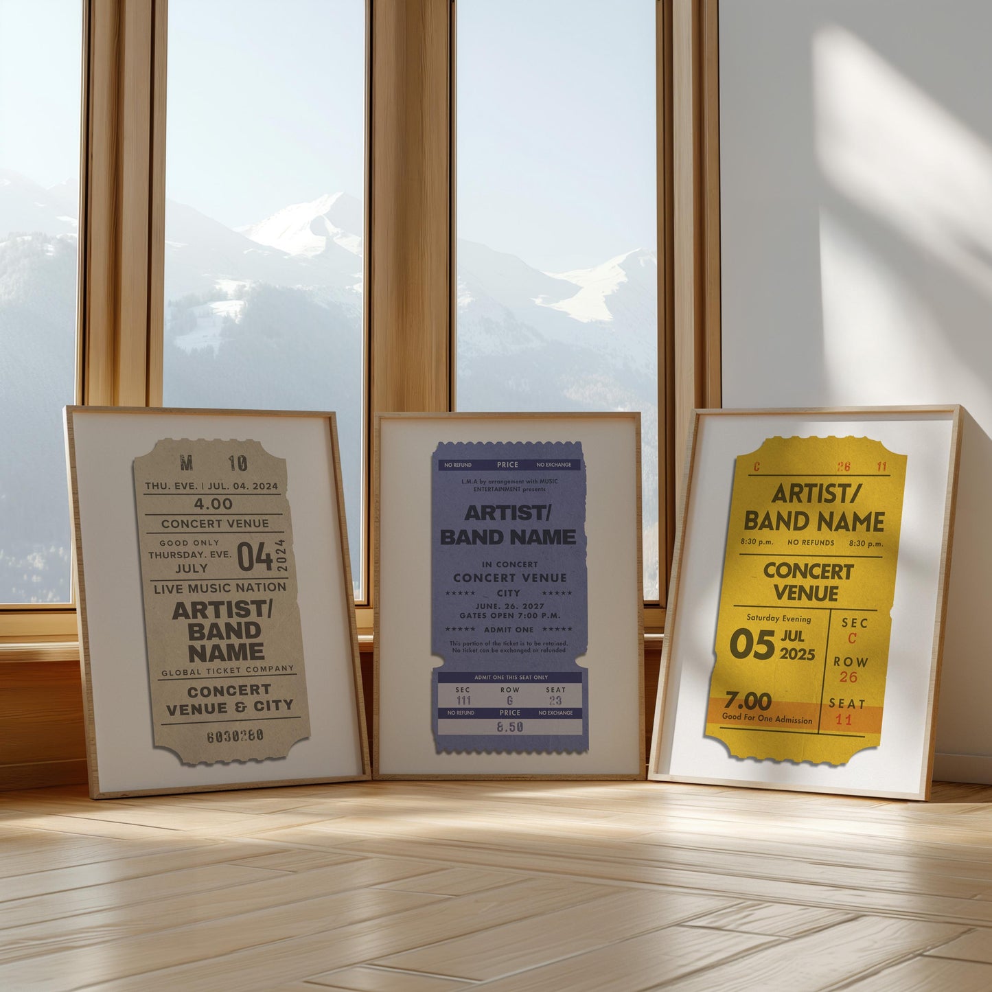 Three colourful art prints leaning against a large window in a livingroom. The art is a vintage blue, beige and yellow design inspired by old live music ticket stubs.