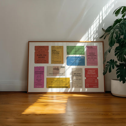 A well lit office space with a large plant and retro colour filled wall art decor. The poster has various old style ticket stubs on it for interrail trips and train journeys from your travels. The art has been made bespoke with your destinations, dates and stations.