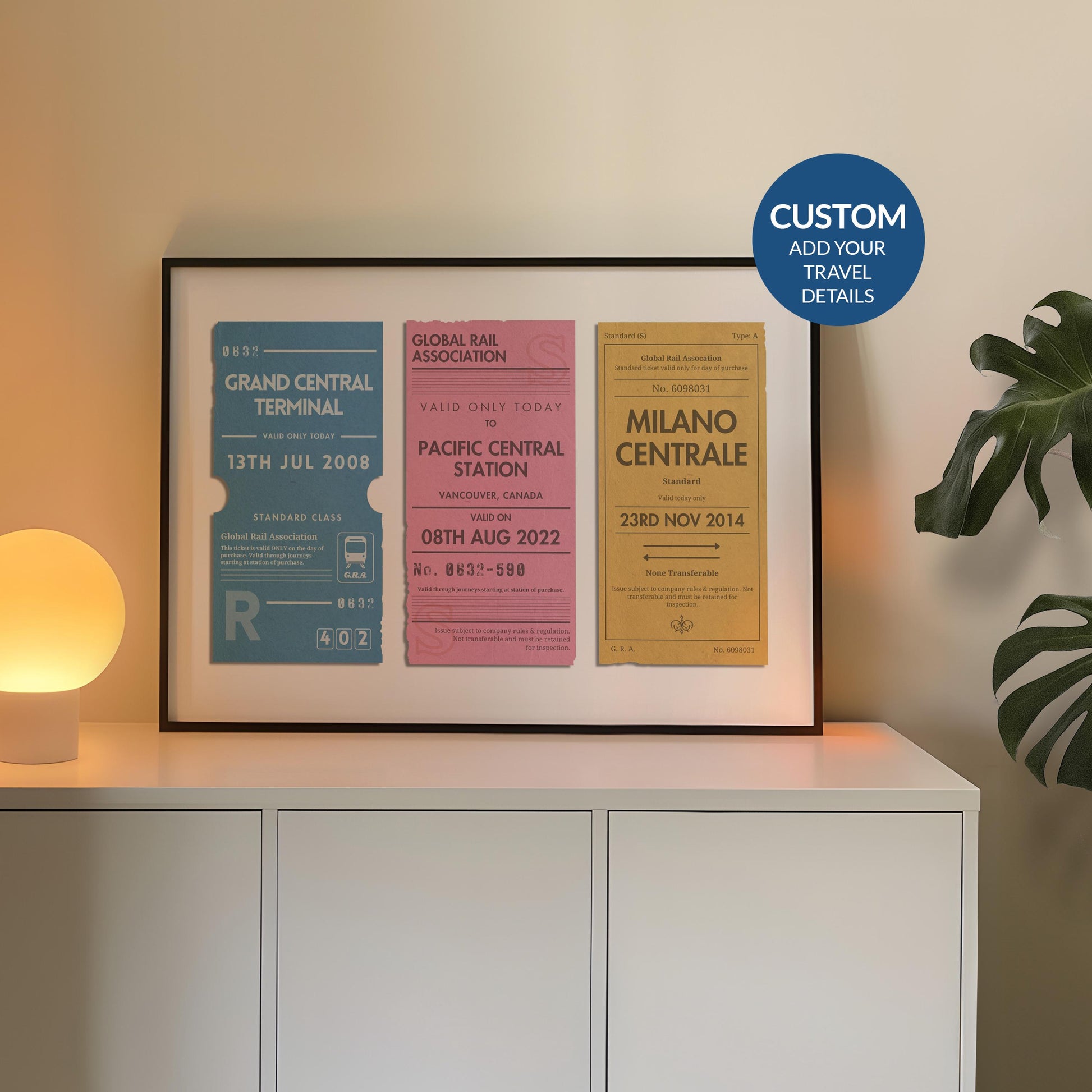 A cosy office space with a round warm lamp and plant on a sideboard. A poster is also on the counter which is a one of a kind railway stubs artwork made for travel lovers as a keepsake for rail journeys and holidays.