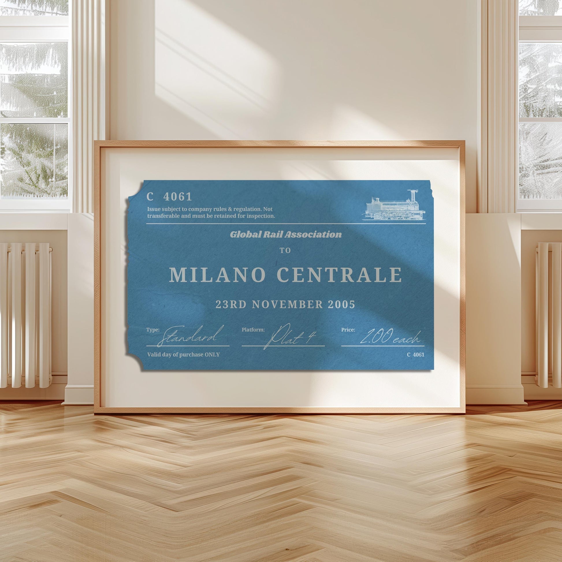 A livingroom with wood herringbone floor and a large art print. It is a custom vintage train ticket stub poster to show off your travels and holidays.