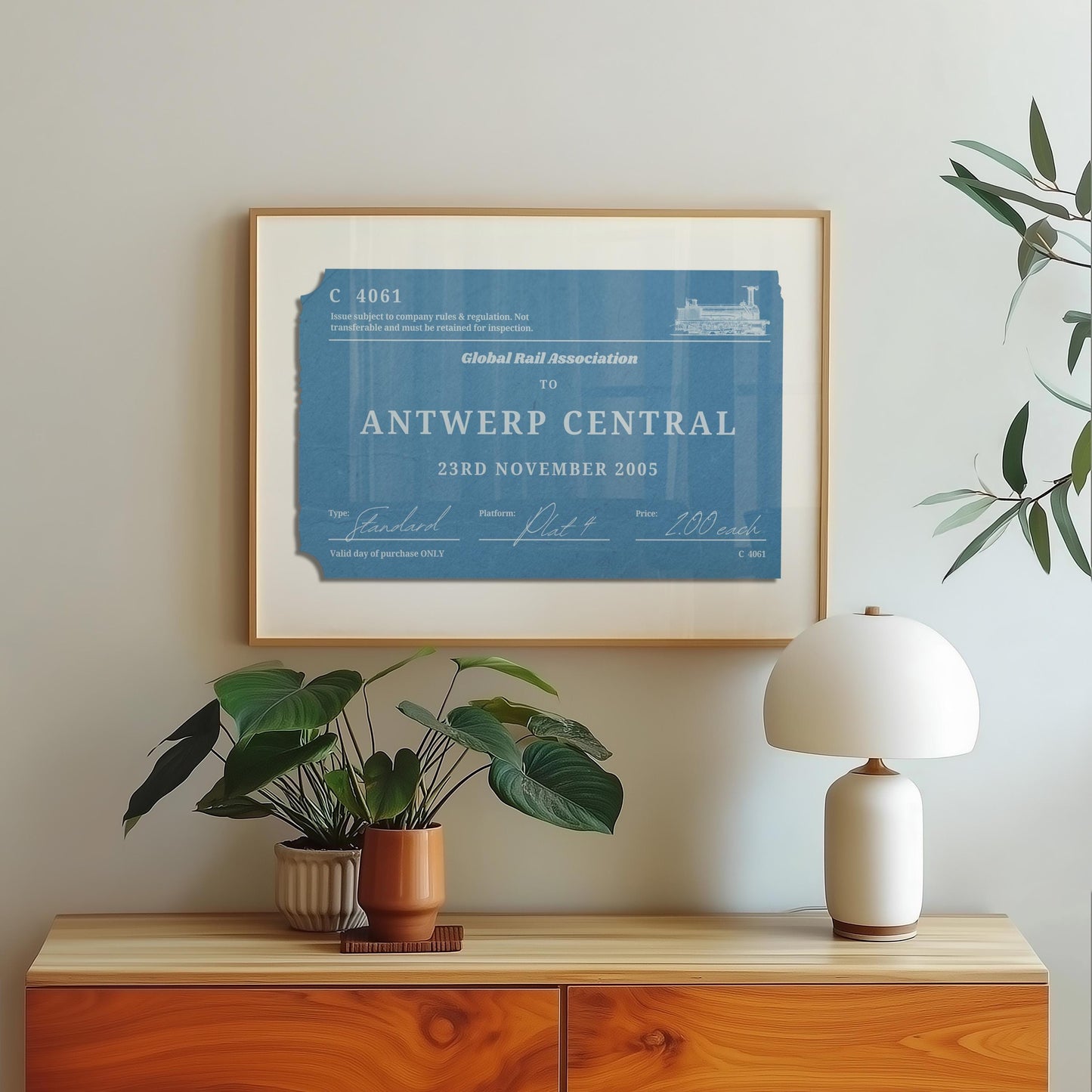 A scandinavian style home with a wood framed poster on the wall which shows a personalised train ticket stub on it. The art is vintage, rustic and bespoke.