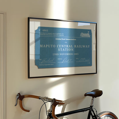 A muted tone of colour art print showing a retro railway tag with custom details on them. The art is on the wall in a european style apartment hallway with a bike in it.