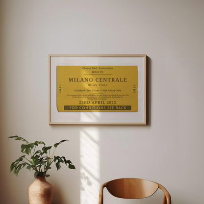 A minimal dining room with a wood curved chair and a plant. On the wall is a framed print of a personalised interrail luggage tag, inspired my old stubs to make a design for frequent travellers and holiday keepsake collectors