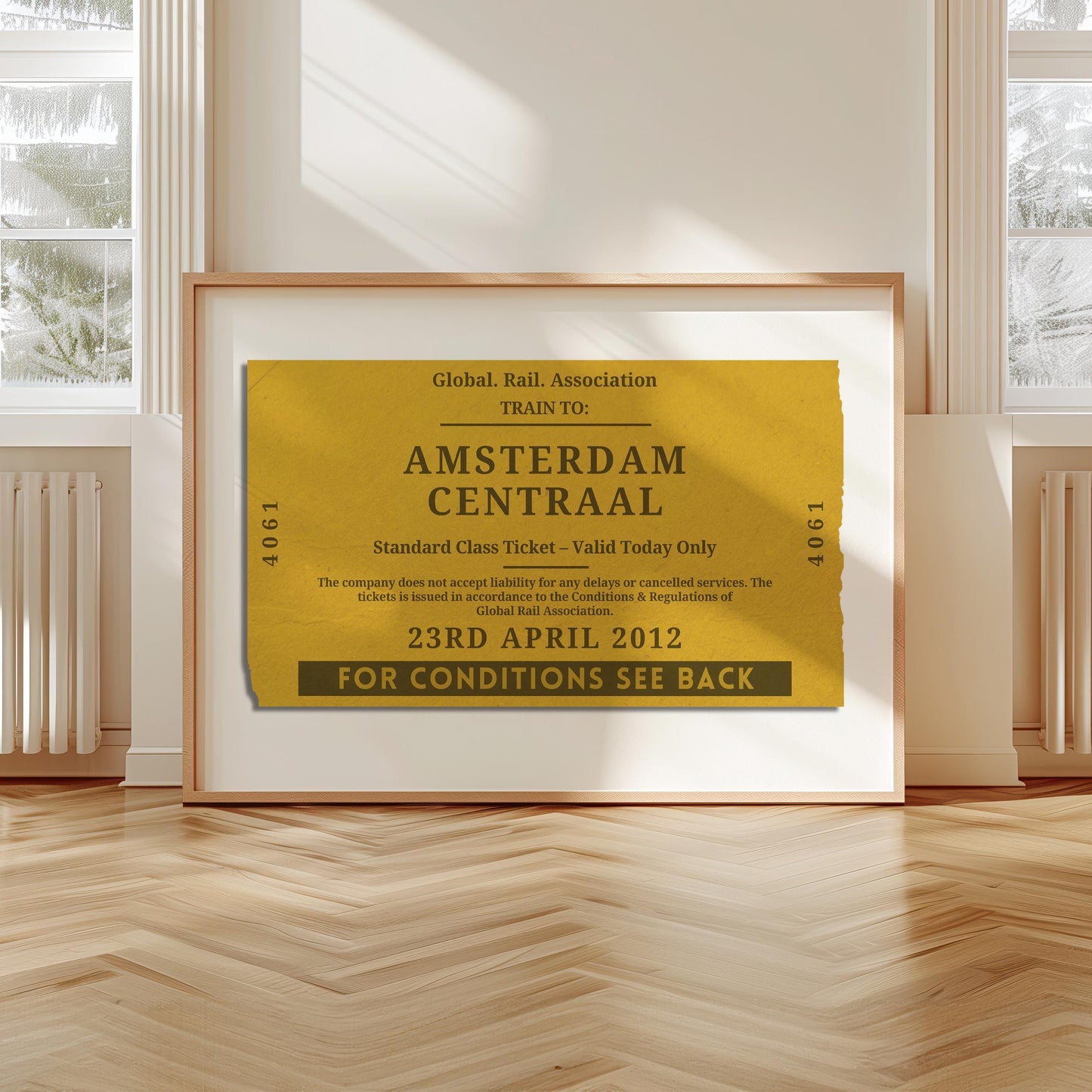 A livingroom with wood herringbone floor and a large art print. It is a custom vintage train ticket stub poster to show off your travels and holidays.
