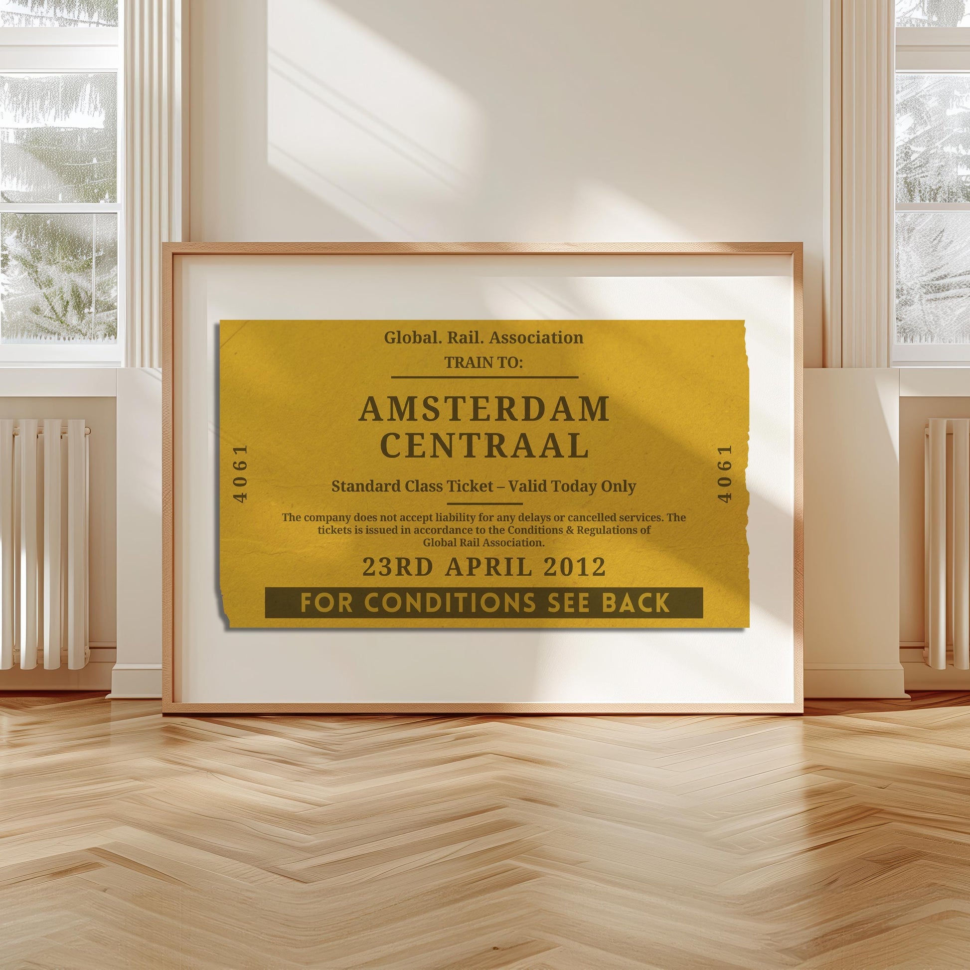 A livingroom with wood herringbone floor and a large art print. It is a custom vintage train ticket stub poster to show off your travels and holidays.