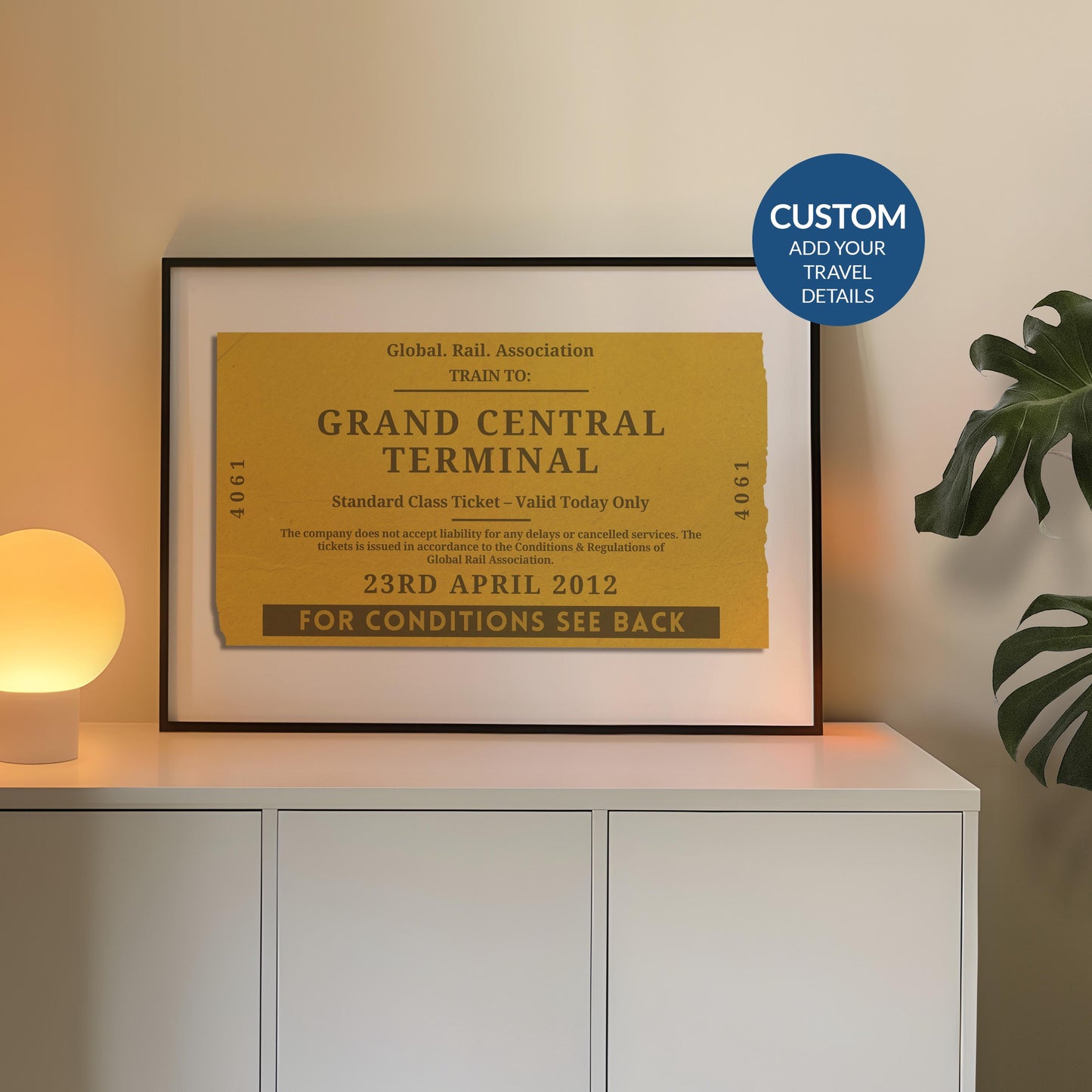 A cosy bedroom with a white sideboard. A poster is on top leaning on the wall which is a one of a kind railway stub artwork made for travel lovers as a keepsake for rail journeys and holidays.