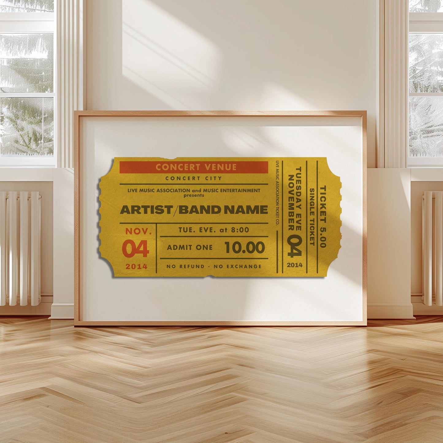 A scandi modern apartment with a large horizontal print leaning on the wall. The art is of a vintage concert ticket stub with personalised text on it.
