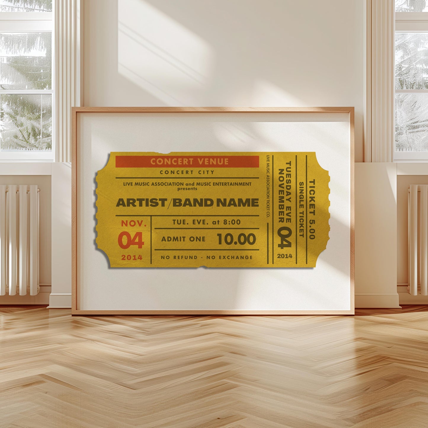 A scandi modern apartment with a large horizontal print leaning on the wall. The art is of a vintage concert ticket stub with personalised text on it.