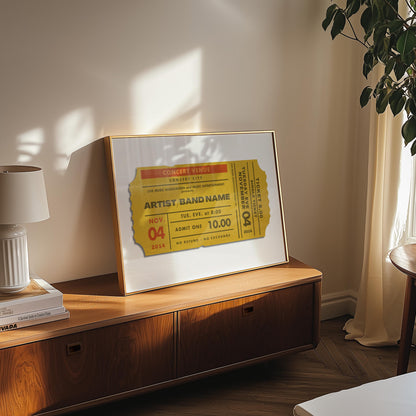 A well lit bedroom with a rich wood cabinet. A mustard print in an oak frame is leaning on the wall showing festival, tour and event memorabilia for your favourite concerts.