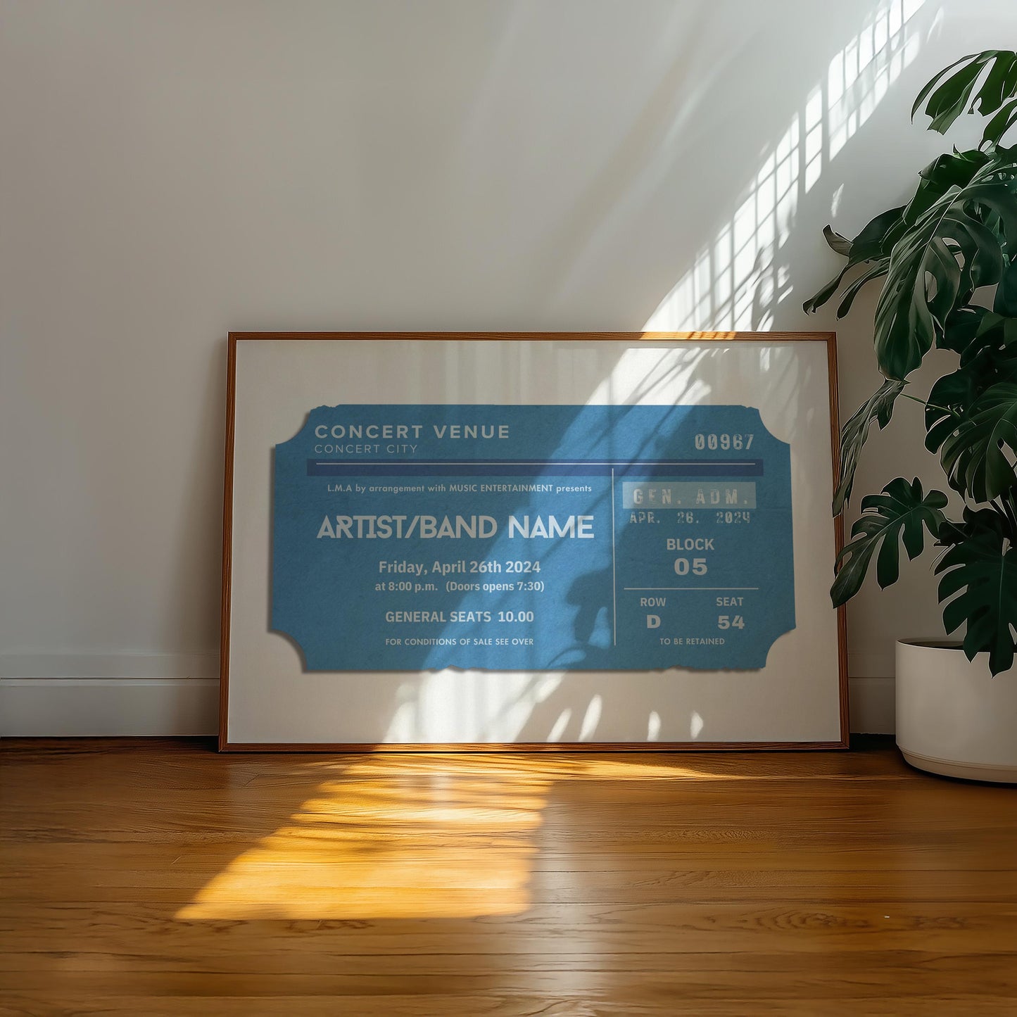 A warm wood floor in a family home office. A large horizontal poster is on the floor near a plant showing worn edge and old faded ticket stubs inspired by old event keepsakes.