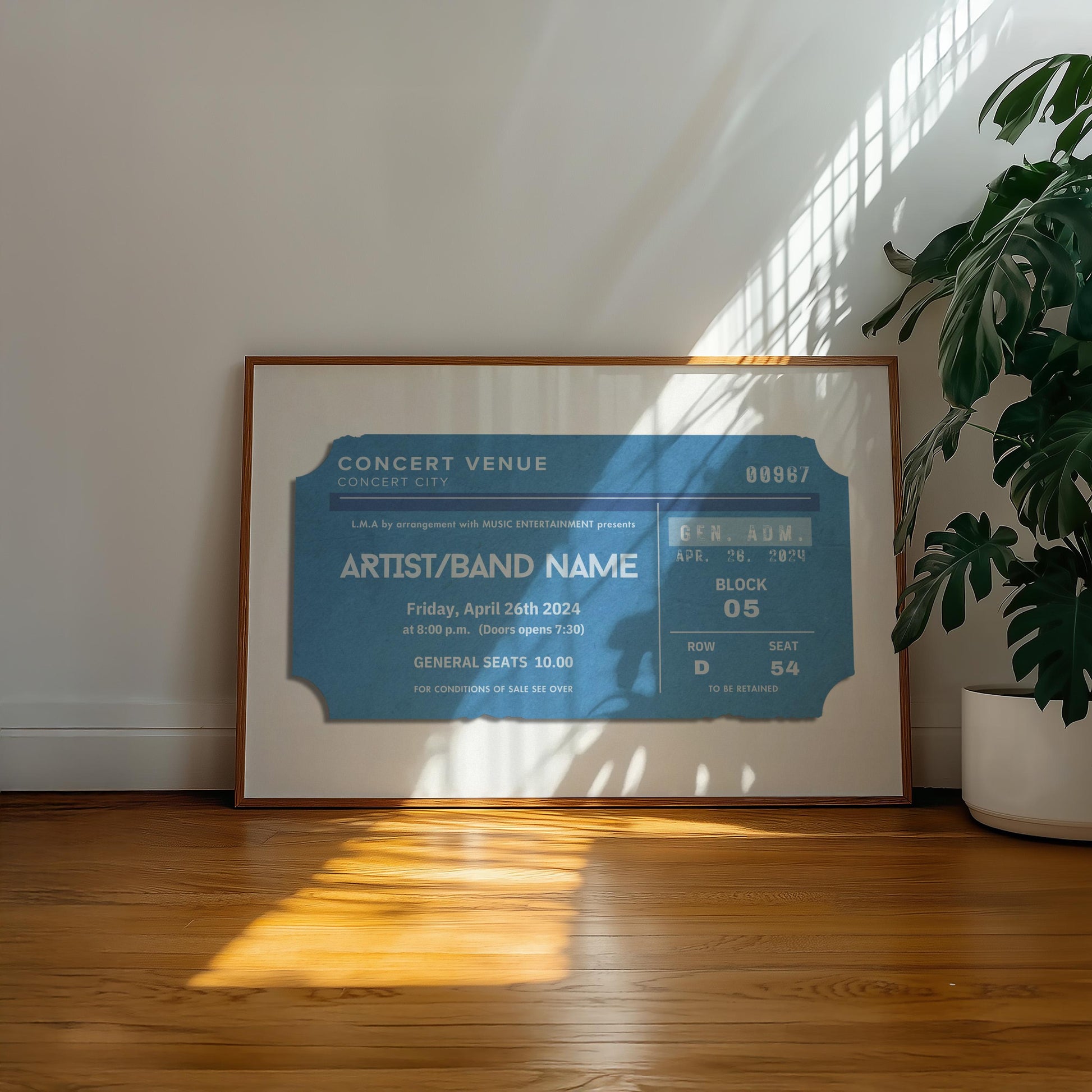 A warm wood floor in a family home office. A large horizontal poster is on the floor near a plant showing worn edge and old faded ticket stubs inspired by old event keepsakes.