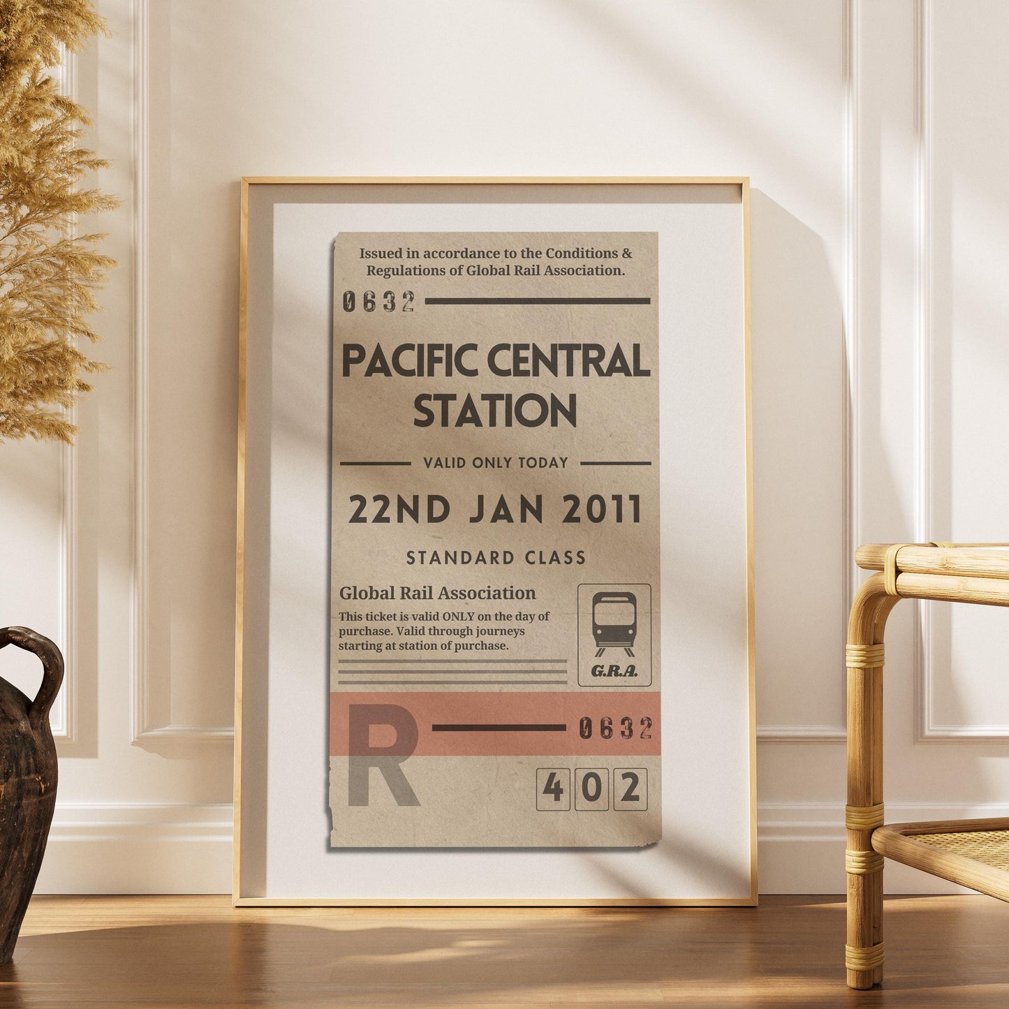 a scandinavian style home with a wood framed poster with personalised train ticket on it