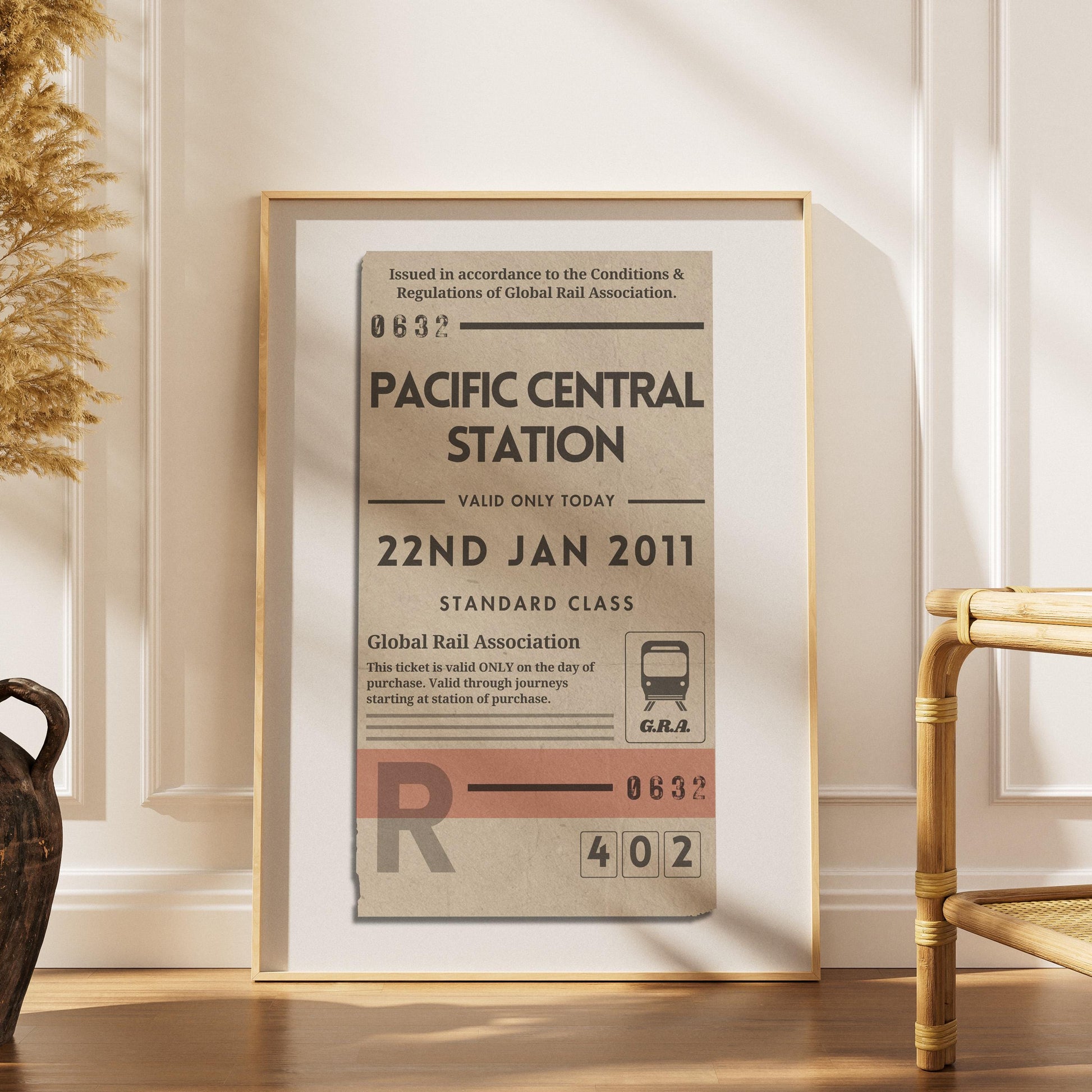 a scandinavian style home with a wood framed poster with personalised train ticket on it