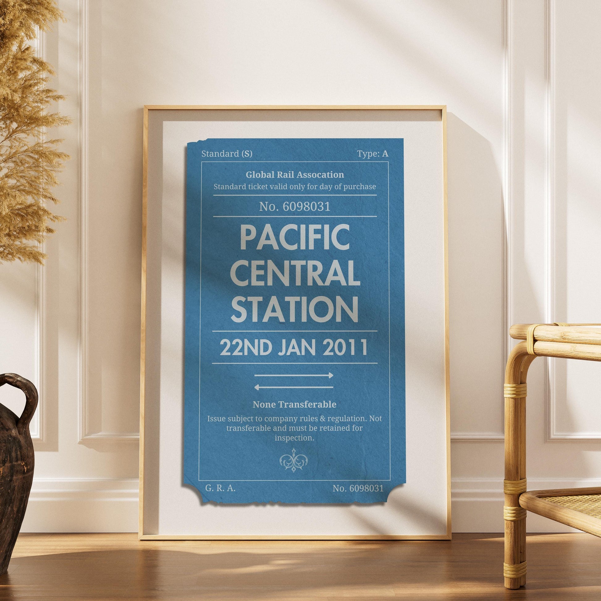 a scandinavian style home with a wood framed poster with personalised train ticket on it