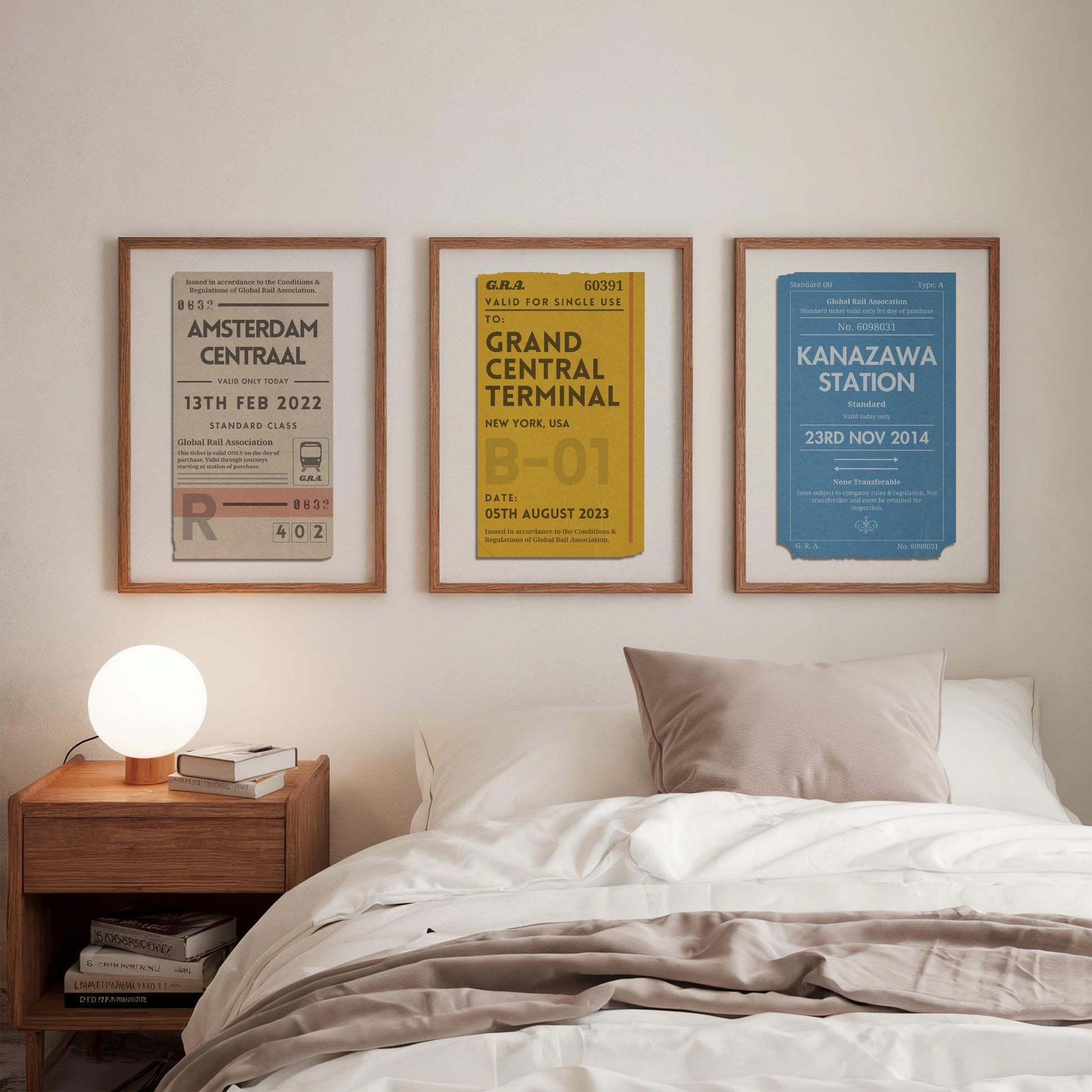 A tryptich trio of art hung above a bed in a cosy bedroom. The wall decor is a epersonalised travel statement for railway trips and adventure memories.