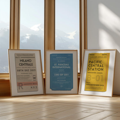 Three framed prints in front of a large window in yellow, beige and blue colour schemes. Each are rustic old train ticket designs with personalised text on each.