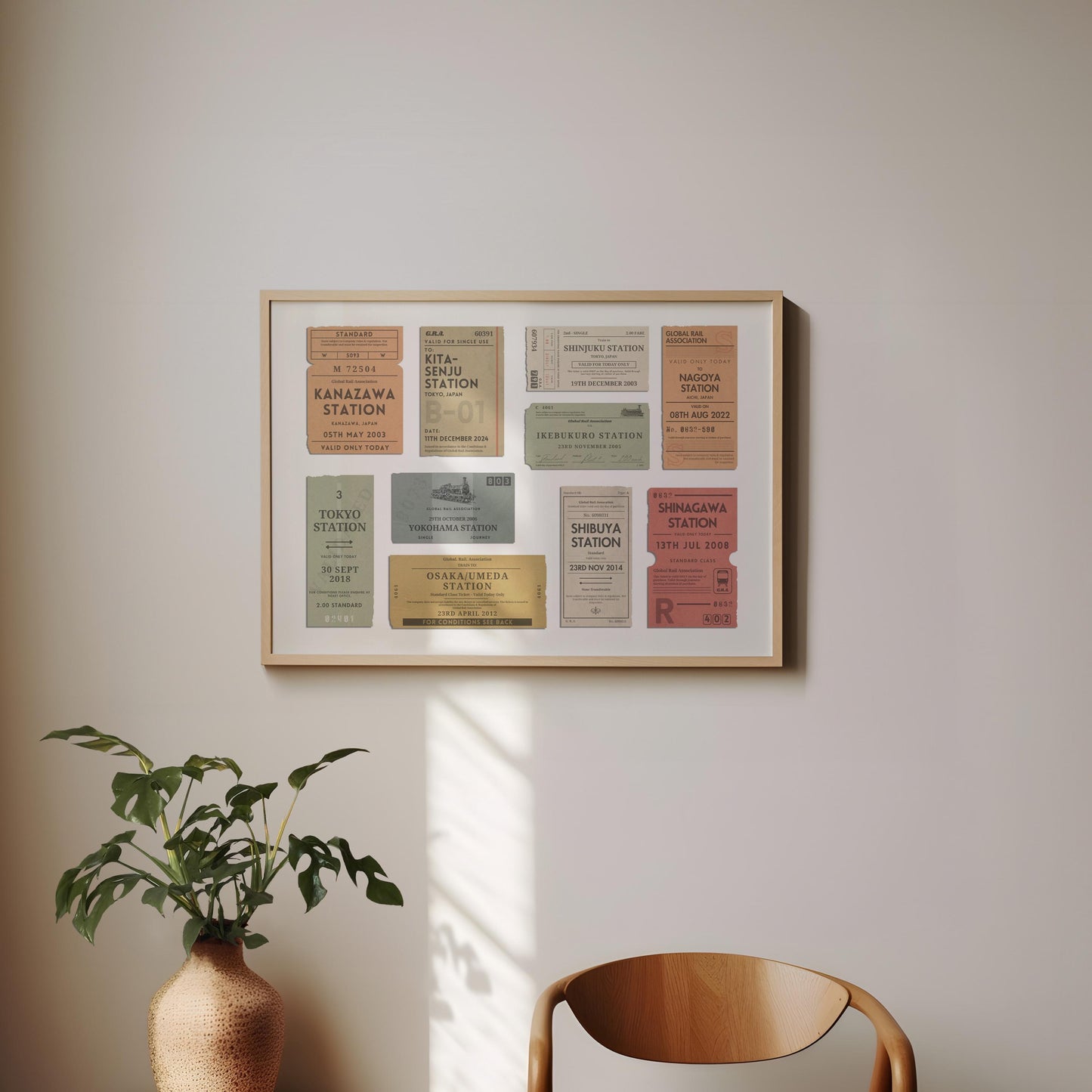 A minimal dining room with a wood curved chair and a plant. On the wall is a framed print of personalised interrail luggage tags, inspired my old stubs to make a design for frequent travellers and holiday keepsake collectors
