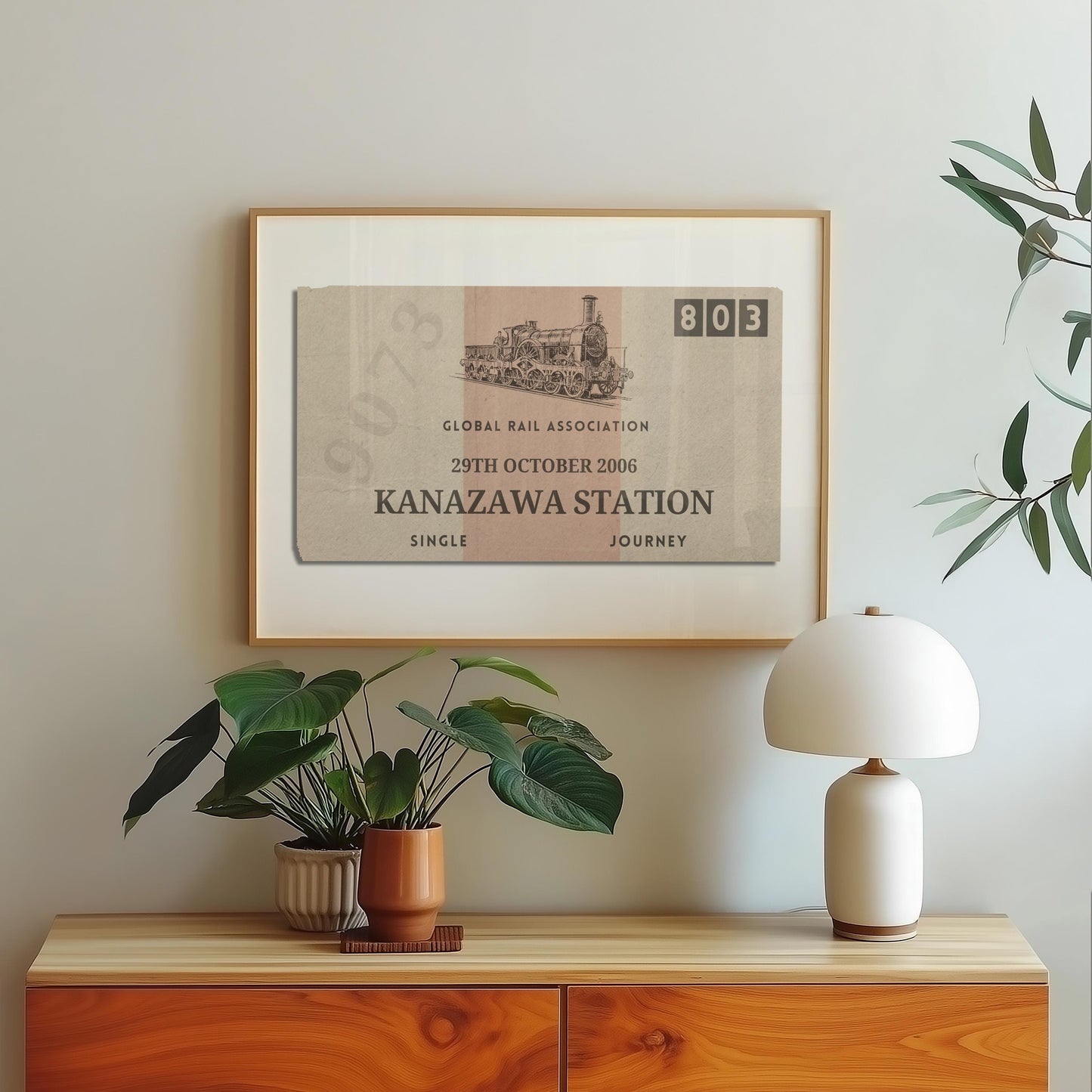 A scandinavian style home with a wood framed poster on the wall which shows a personalised train ticket stub on it. The art is vintage, rustic and bespoke.