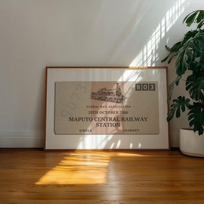 A well lit office space with a large plant and retro colour filled wall art decor. The poster has an old style ticket stub on it for interrail trips and train journeys from your travels. The art has been made bespoke with your destination, date and station.