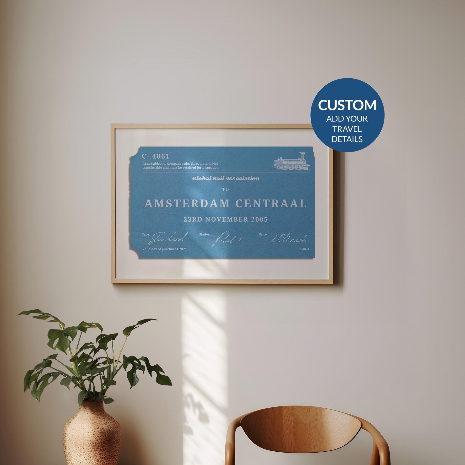 A minimal dining room with a wood curved chair and a plant. On the wall is a framed print of a personalised interrail luggage tag, inspired my old stubs to make a design for frequent travellers and holiday keepsake collectors