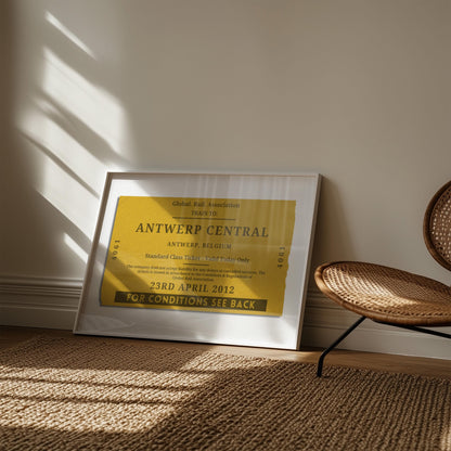 A muted tone of colour art print showing a retro railway tag with custom details on them. The art is in a rustic bedroom with a rattan rug and chair.