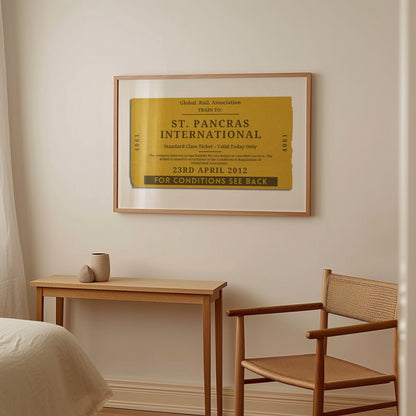 A warm light wood furnished bedroom with a large horizontal framed wall art. It is a custom unique rail tag print designed as a memory filled gift for holidays, gap years or honeymoon décor.