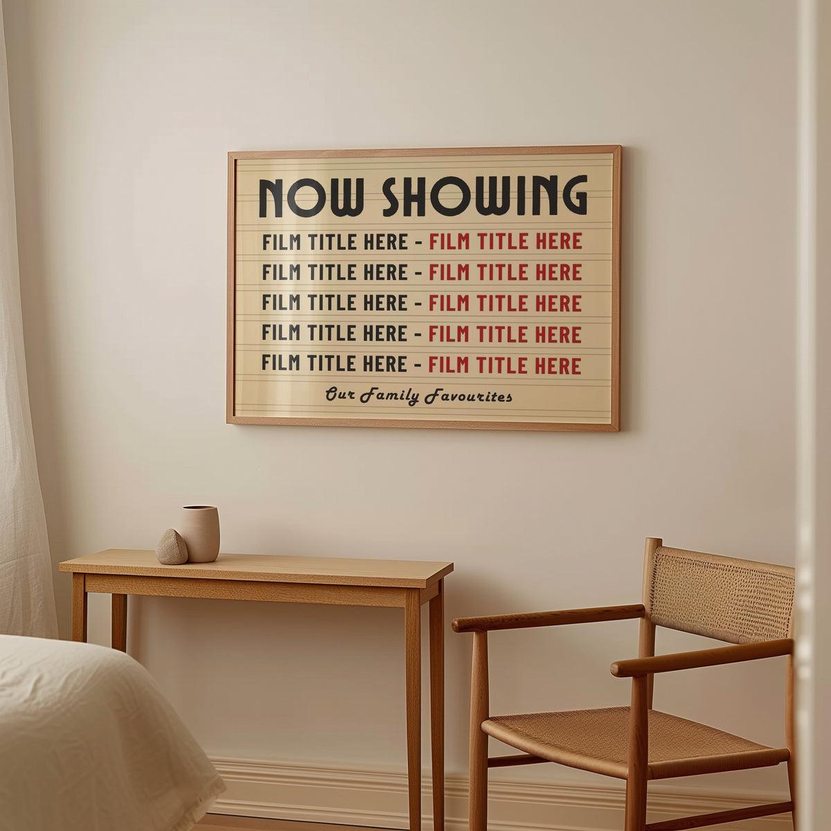 A bedroom with soft rattan and wood furniture featuring a large horizontal framed print. The print is a vintage yellow colour with marquee style details showing 10 personalised film titles chosen by the gift recipient.