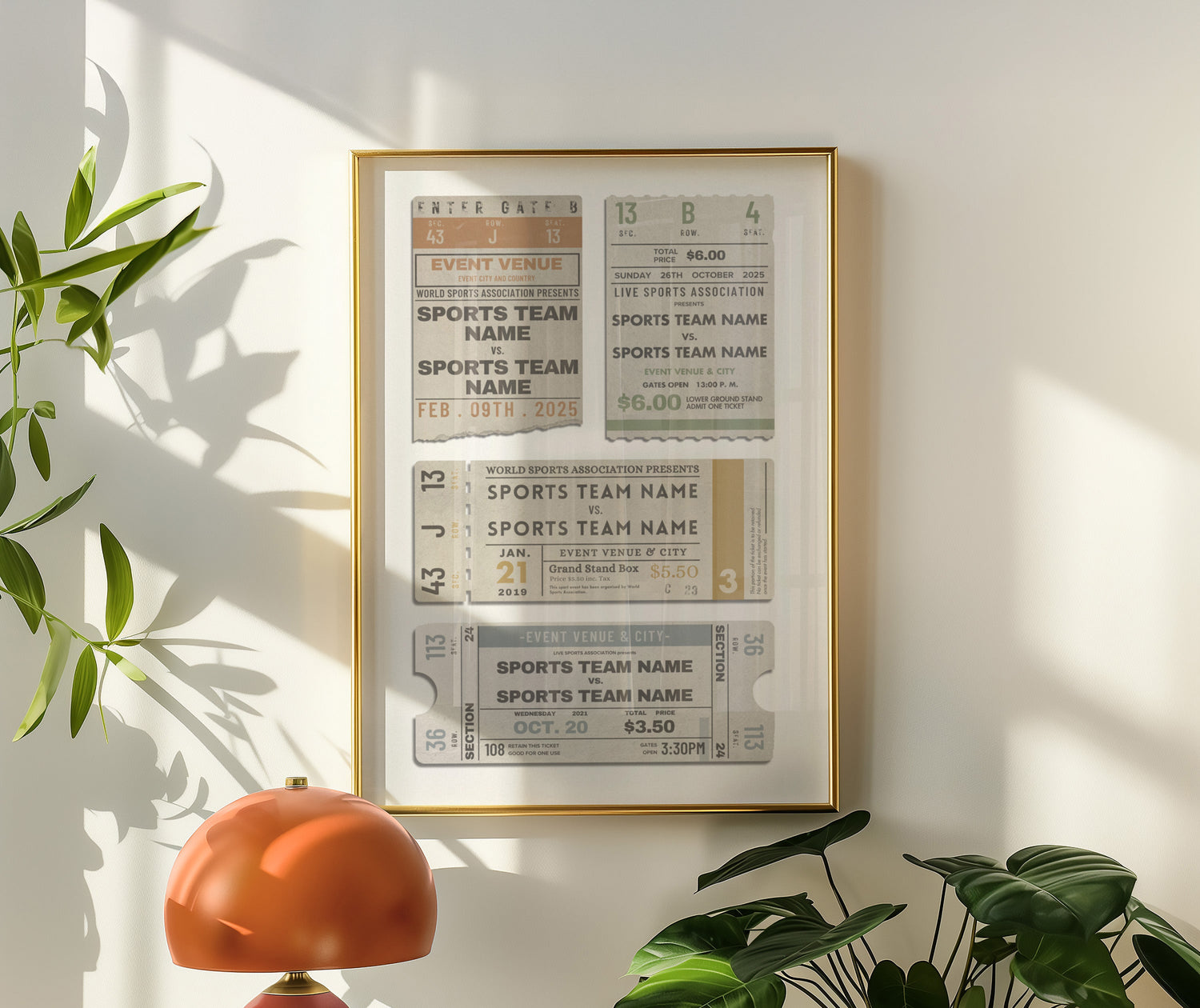 Framed sports team nameplate art on a wall with a lamp and plants below.