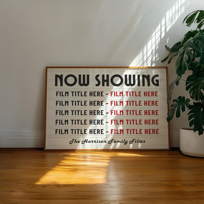 A well lit living room with a vintage poster on the wall saying "NOW SHOWING" and listings of custom movie titles. The art says "Lights. Camera. Action" and is a perfect addition to a home cinema or theatre